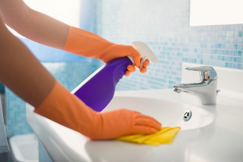 Professional cleaner following safe working practices during a carpet clean