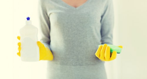 Cleaner using protective equipment while handling carpet cleaning products